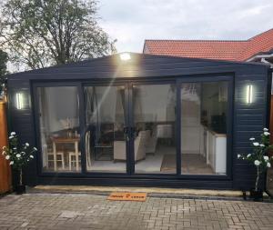 a large conservatory with glass doors on a house at 1-Bed Studio with Parking Ideal for Couples in Newcastle upon Tyne