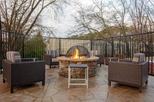 a patio with a fire pit and two chairs at TownePlace Suites by Marriott Gainesville in Gainesville