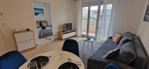 a living room with a couch and a table at Marin apartment with swimming pool in Antibes