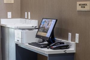斯莱德尔SpringHill Suites by Marriott Slidell的一张带电脑、键盘和电话的桌子