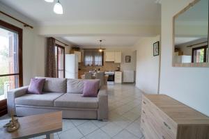 a living room with a couch and a kitchen at Almond's Room in Mirina +18 photos