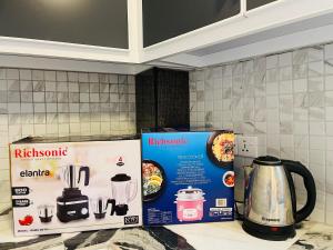 a kitchen counter with a box and a kettle on it at Blue Moon Villa in Weligama