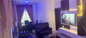 a living room with a waiting room with chairs at Life Apartment in Aguda