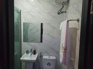 a bathroom with a sink and a toilet and a mirror at Life Apartment in Aguda +12 photos