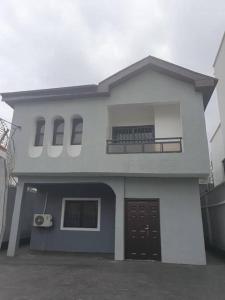 a large white house with a balcony on it at Life Apartment in Aguda
