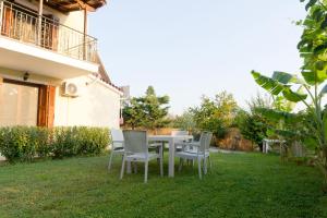 a table and chairs in the yard of a house at Almond's Room in Mirina
