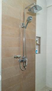 a shower with a shower head in a bathroom at Nguchiro Palace in Moshi