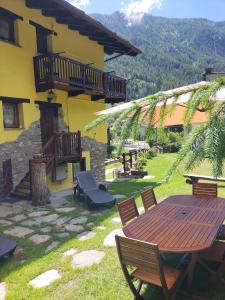 a patio with a table and chairs and a building at Maison du Soleil- CIR VDA Valtournenche n 0204 in Valtournenche