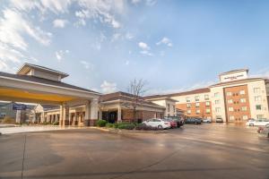 a hotel with cars parked in a parking lot at SpringHill Suites by Marriott Denton in Denton