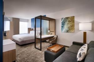 a hotel room with a bed and a couch at SpringHill Suites by Marriott El Paso Airport in El Paso +19 photos