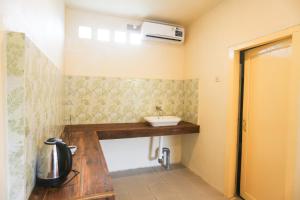 a small bathroom with a sink and a sink at Komodo Shores Homestay in Labuan Bajo