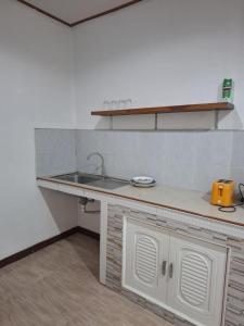 a kitchen with a sink and a counter at Patcharin house 1 in Ko Lanta Yai