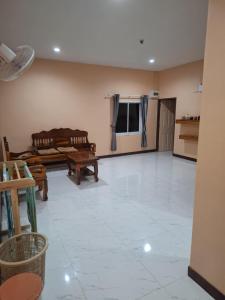 a large living room with a white tiled floor at Patcharin house 1 in Ko Lanta Yai
