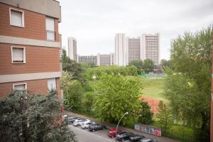 a city street with cars parked in a parking lot at In Fiera 14 Apartment in Bologna