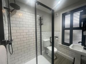 a bathroom with a toilet and a sink at Greta House in Keswick +23 photos