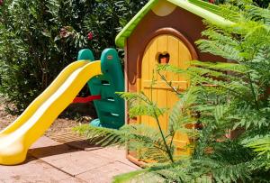 a play set with a slide and a play house at Casa Giulù- in Palermo