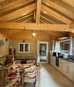 a kitchen with wooden ceilings and a table with chairs at Studio Au Cosy Spa in Riedheim +5 photos