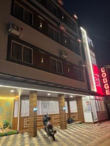 a motorcycle parked outside of a building at night at CLASSIC COMFORT Lodge in Mangalore +24 photos