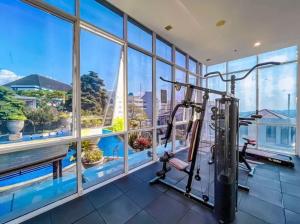 a fitness room with a gym with a treadmill at Villa Fitsu Bhuvana in Ciawi Bogor