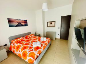 a bedroom with a bed with an orange blanket at Casa Adele in Salerno