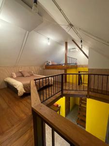 a bedroom with a bed and a staircase in it at Baibon3 Homestay Thalang Phuket in Ban Na Nai