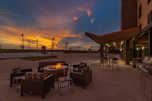 a patio with a fire pit and chairs and a building at TownePlace Suites by Marriott Dallas Mesquite in Mesquite