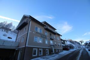 a building on a street with snow on the ground at Apartments Luidold in Schladming