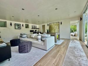 a living room with a white couch and a table at The Glass House Montecito in Santa Barbara