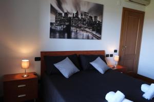a bedroom with a bed with two lamps on tables at hopefco in Fiumicino