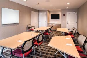 a classroom with tables and chairs and a flat screen tv at TownePlace Suites by Marriott Merced in Merced +28 photos