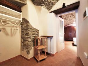 a hallway in a house with a stone wall at Hostdomus - Le Petite Garnotte in Pragelato