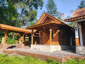 a home with a roof on top at Lawang Pitu Untuk keluarga in Sleman