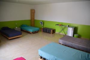 A bed or beds in a room at MEETING POINT- Tarrafal Group Reservations