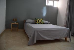 A bed or beds in a room at MEETING POINT- Tarrafal Group Reservations