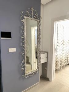 a mirror on a blue wall in a room at Villa Luca Free Parking in Sarajevo +17 photos