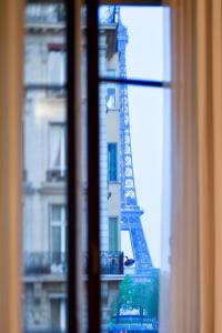 a view of the eiffel tower from a window at Le Metropolitan, Paris Tour Eiffel, a Tribute Portfolio Hotel in Paris