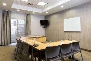 a conference room with a table and chairs and a whiteboard at SpringHill Suites Indianapolis Fishers in Indianapolis +15 photos