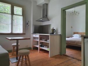 a room with a kitchen and a bed and a table at Apartamenti Strand in Saulkrasti