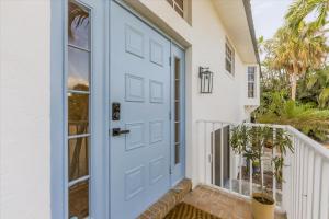a blue door on a house with a porch at Dock Holiday in Sanibel