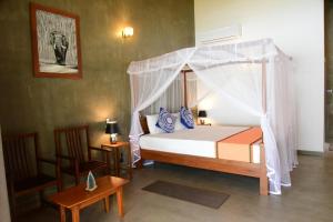 Postel nebo postele na pokoji v ubytování Villa Bell Rose Hikkaduwa