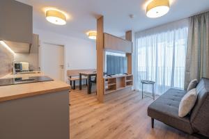 a kitchen and living room with a couch and a table at Apart Sonnenbichl in Sölden