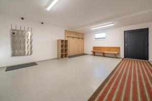 an empty room with a bench and a rug at Apart Sonnenbichl in Sölden