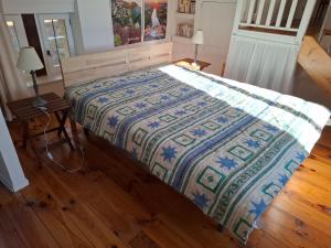 a bedroom with a bed with a quilt on it at Domaine du Bois Noir in Milhac +20 photos