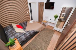 a small bedroom with a bed and a desk at REZYDENCJA ZATOR in Zator