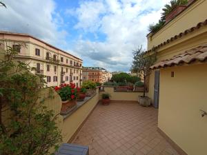 a balcony of a building with plants and flowers at Vatican Penthouse - Terrace with view in Rome