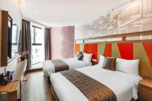 a hotel room with two beds and a mural at Mandala Retreat Horizon Resort Mũi Né in Mui Ne +51 photos