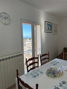 a dining room table with a view of the ocean at Palazzo Giannotte Suite & Spa in Ostuni