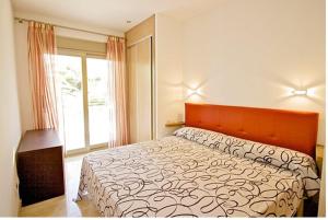 a bedroom with a large bed and a window at Villa Saturn in Alcudia
