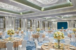 a ballroom with tables and chairs in a room with a ceiling at The Ritz-Carlton, Pune in Pune +80 photos