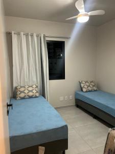 Giường trong phòng chung tại Res Leomarian 2 quartos Praia do Morro - Guarapari